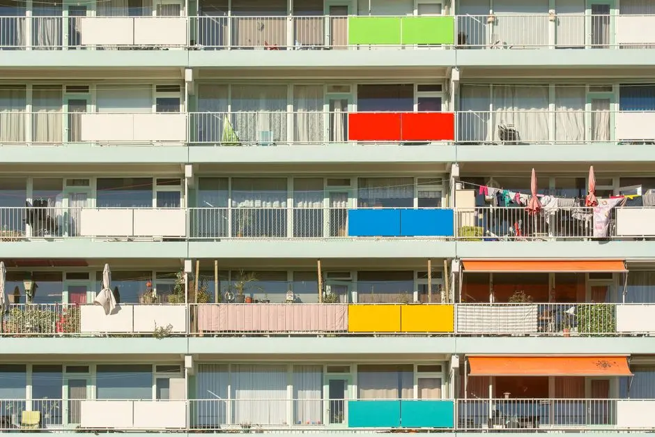 A vibrant display of colorful balconies on a residential building. Perfect for urban lifestyle themes.
