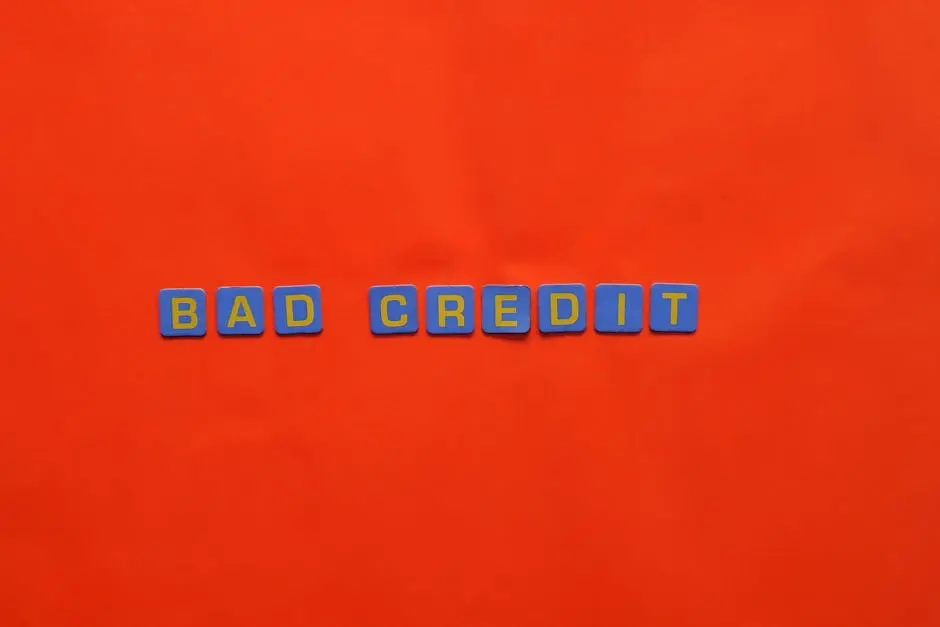 Blue letter blocks spelling ‘Bad Credit’ on an orange background.