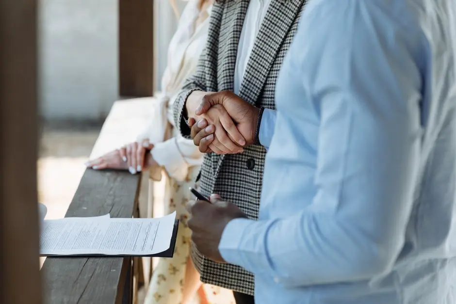 Landlord and tenant shaking hands after signing a lease